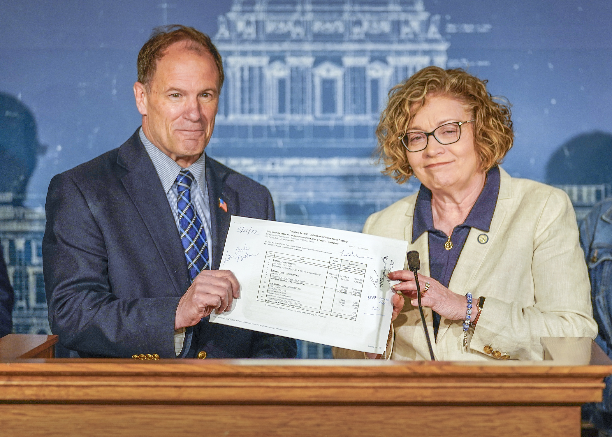 Rep. Paul Marquart and Sen. Carla Nelson, co-chairs of the taxes conference committee, announced and signed a tax bill agreement during a press conference May 21. (Photo by Andrew VonBank)